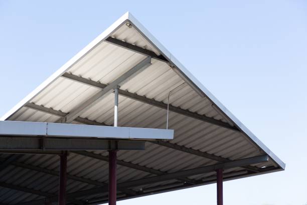 istock The corner of an old roof structure rises into the blue sky, forming triangles. 1479069676