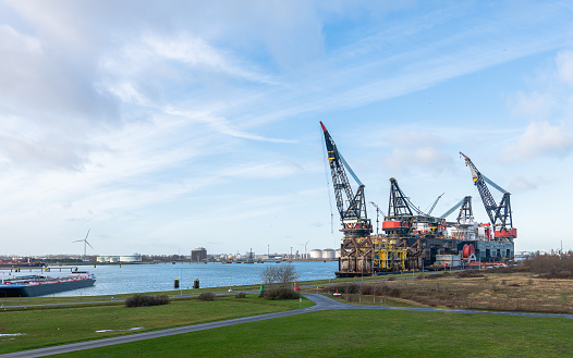 The Thialf semi-submersible crane vessel under cloudy sky