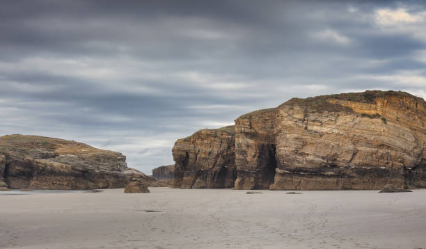 istock Beautiful rainy cloudscape over rugged cliffs in As Catedrais beach in Lugo, Spain 1479074078