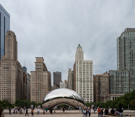 Chicago, United States – September 08, 2022: Cloud Gate sculpture in Chicago's Millennium Park with people on the street