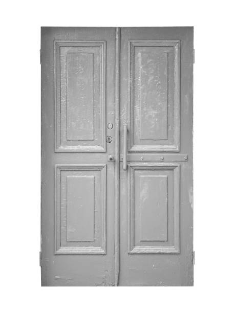 Old shabby gray textured wooden doors is isolated on white background.