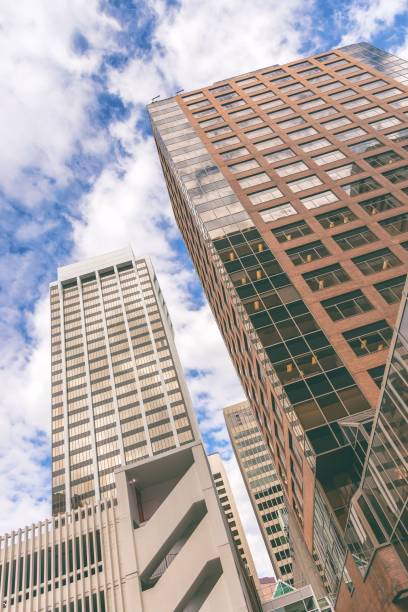 istock three high rise office buildings against a cloudy sky, in the middle of an intersection 1479076844