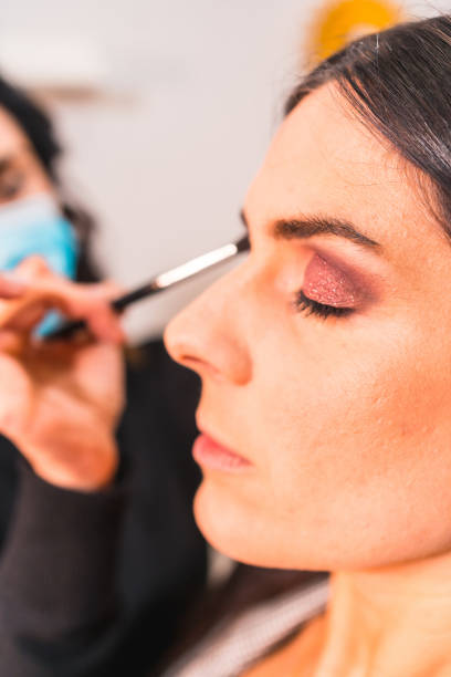 istock Makeup artist with a protective mask working in a beauty salon 1479078170