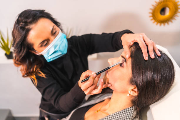 istock Makeup artist with a protective mask working in beauty salon 1479078179