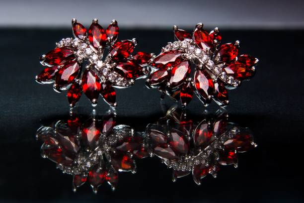 Ruby crystal earrings on black surface, luxury fashion jewelry