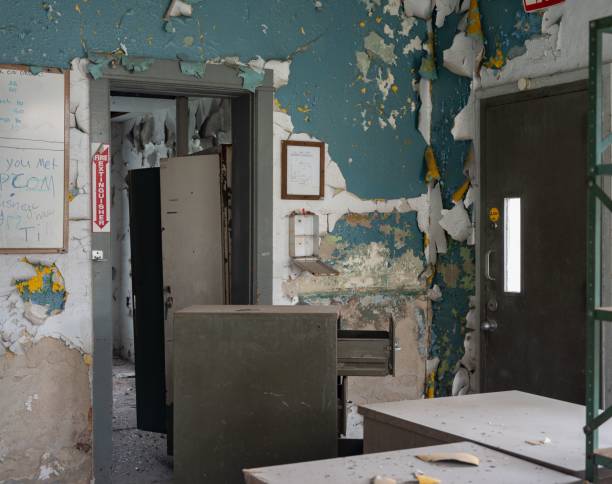 istock a desk in an abandoned building with a missing piece of wall paper 1479079337