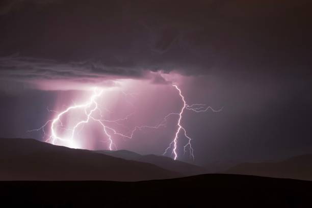 istock Dramatic image of a stormy sky above a mountain range, illuminated by a brilliant lightning bolt 1479080255