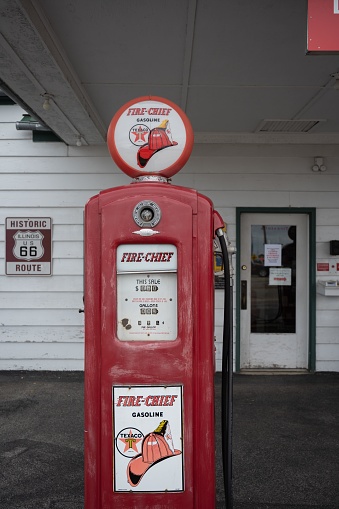 Dwight, United States – August 25, 2022: A vintage bright red gas pump in a rural gas station Texaco