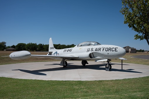 Weatherford, United States – September 15, 2022: A jet airplane is parked on a grassy airstrip, with a circular runway