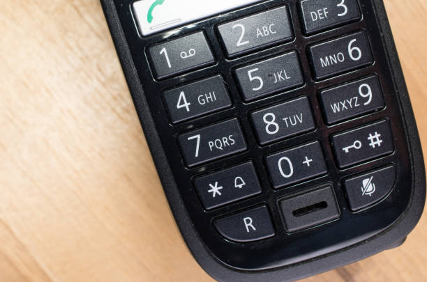 Cordless home or office telephone on white background. Top view of a landline phone with copy space.