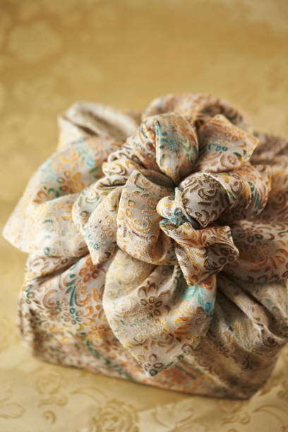 istock Vertical shot of a gold traditional gift bag, on a patterned surface 1479090310