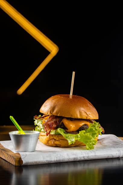 istock Delicious bacon and lettuce burger, freshly served on a rustic wooden board 1479091242