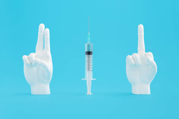 istock Syringe with a mannequin finger showing signs on a blue background 1479093843