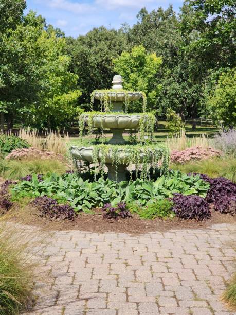 istock a stone walkway next to a fountain in the park surrounded by greenery 1479095251