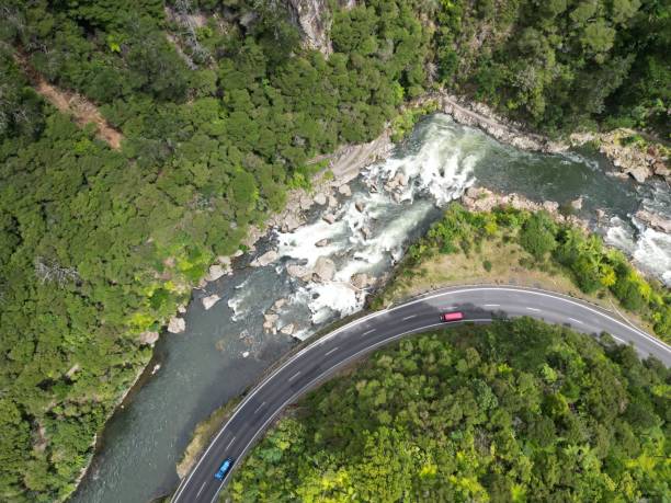 istock a car driving on the road through the woods next to a river 1479095784