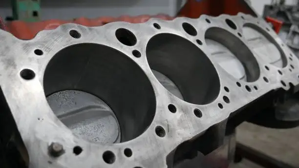 Image of an engine block head in a machine shop environment