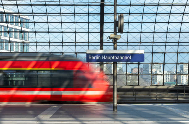 Blurred Motion Of Train At Railroad Station Blurred Motion Of Train At Railroad Station, Berlin Hauptbahnhof train stations stock pictures, royalty-free photos & images