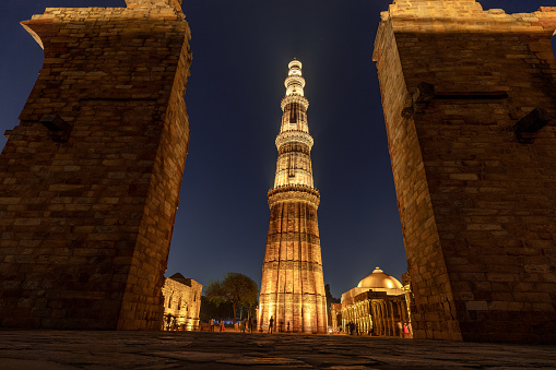 Beautiful low angle view of Qutub Minar between through the shattered walls