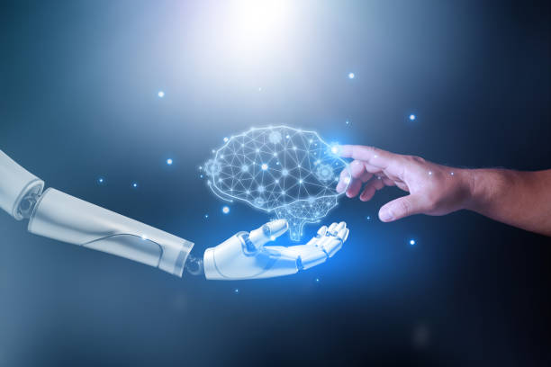 istock Machine learning, Hands of robot and human touching a Ai brain, Science and artificial intelligence technology, innovation and futuristic. Robotic holding a mechanical artificial intelligence brain. 1479102974