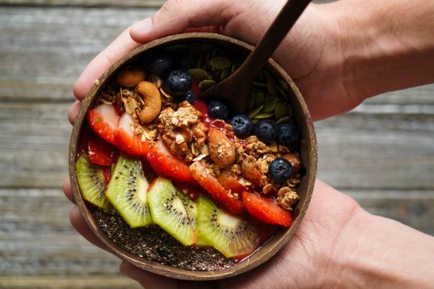 istock two hands hold a bowl of fresh fruits 1479103156