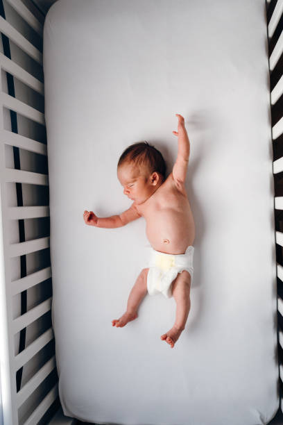 istock Baby boy stretching in the crib 1479109860