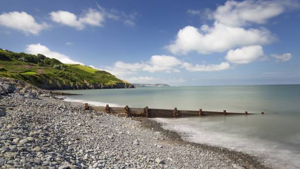 istock a stone shoreline and a calm ocean with rocks in it 1479110764