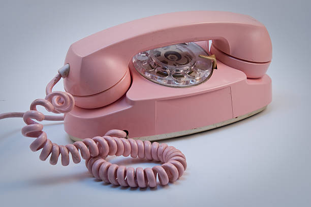 Pink telephone isolated on a pure white background, no dot in the white area so no need to cut-out e.g. can be dropped directly on to a white web page seemlessly.