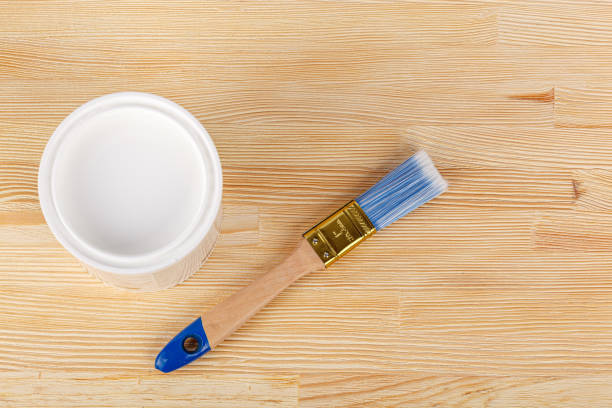 istock white paint with a brush on a wooden background with texture 1479113527