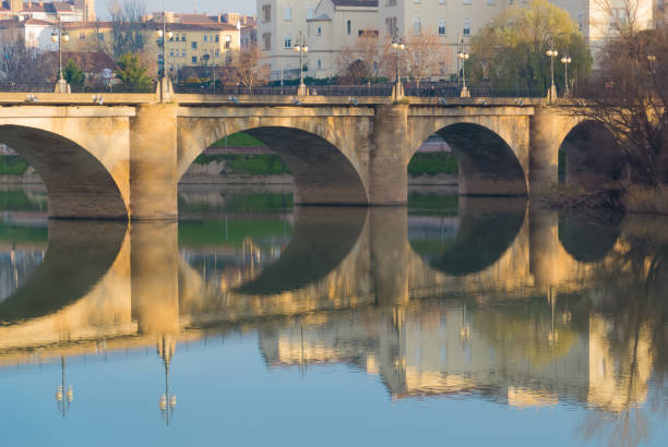 istock Stone bridge over a river reflecting in the water 1479115102