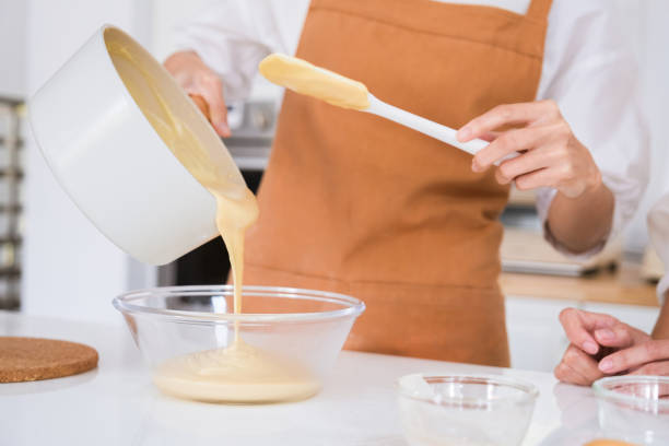 istock Woman pouring liquid mousse into bowl. 1479115334