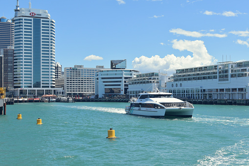 Auckland, New Zealand – January 05, 2021: View of Fullers catamaran ferry leaving Auckland downtown terminal