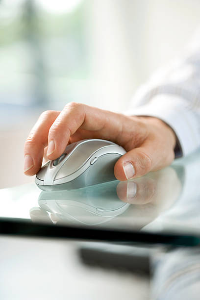 istock Close-up of a mans hand on a silver computer mouse 147911723
