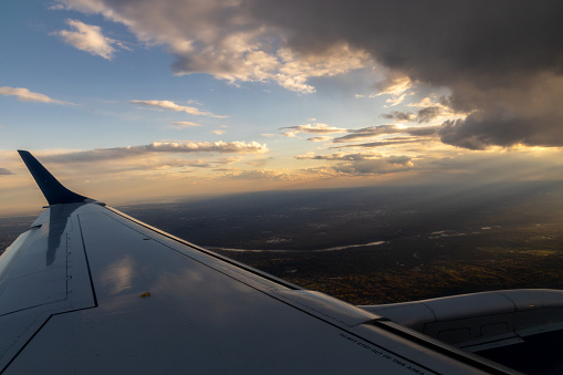 Plane wing with a sunset and sunbeams