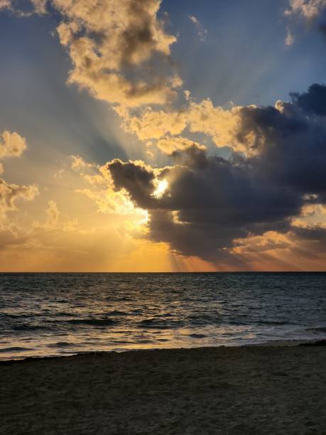 istock a sun is shining brightly into the clouds above the water 1479121152