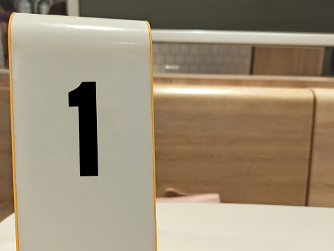 A closeup Picture of board with Number one written on it