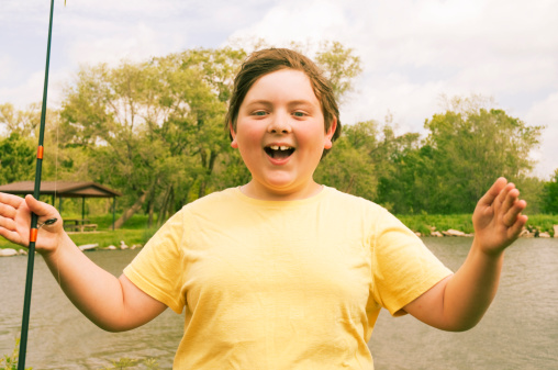 Boy exaggerating how big the fish was; digitally cross-processed