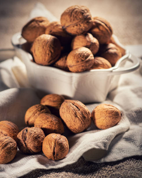 still life with walnuts in a bowl stock photo