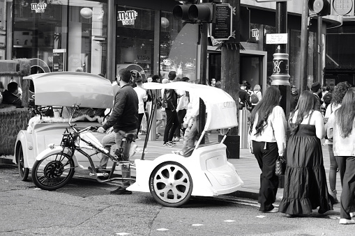 London, England 20 August 2021: Green Eco friendly, sustainable methods of travelling around central London.  Walk or cycle and even hire a guy with a cycle rickshaw to take you where you need to go.