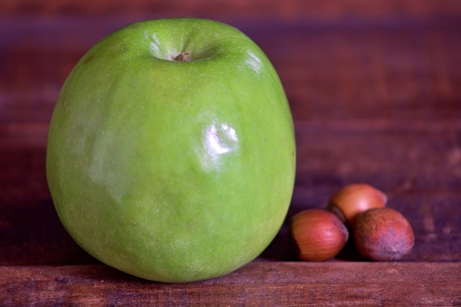 green apple on aged wood