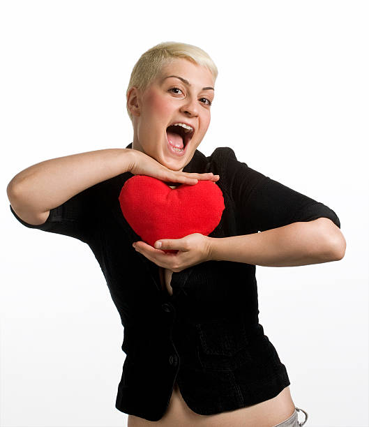 istock girl holding heart shape pillow 147912402
