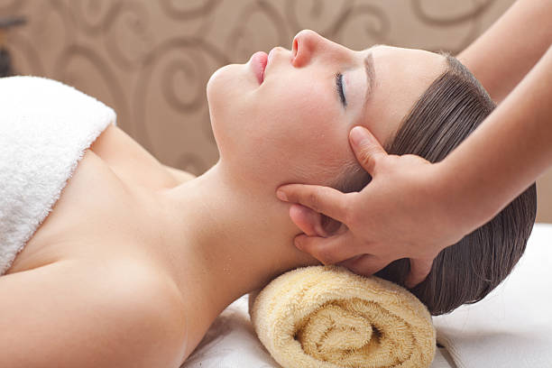 Young woman receiving head massage stock photo