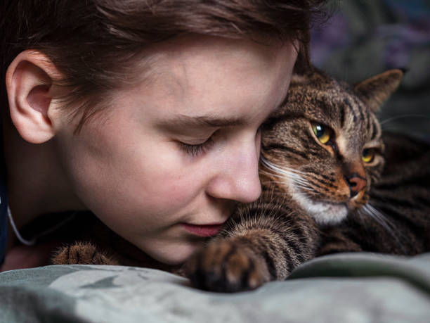 istock A teenage boy hugging a striped cat 1479124923
