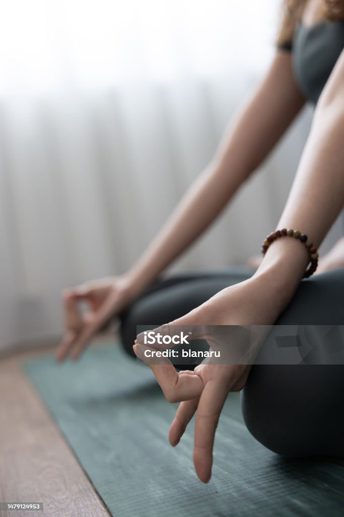 Mudra Apana Vayu Detail of apana mudra executed in lotus position by a young woman. 35-39 Years Stock Photo