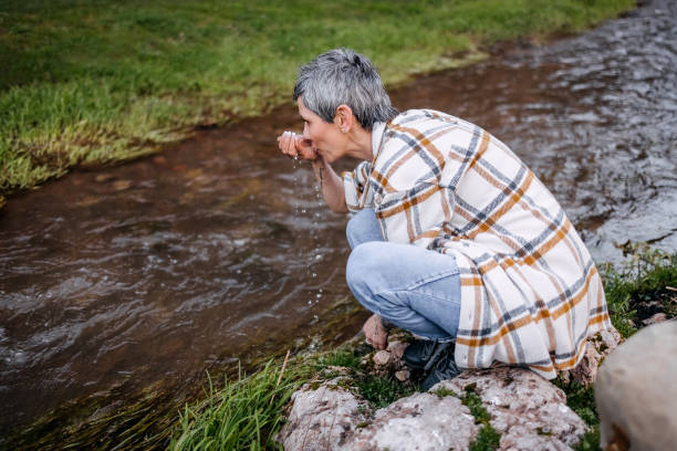 istock Woman resting on a river in the mountains 1479125340