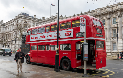 London. UK- 01.08.2023. The rear view of a the iconic old Routemaster  double decker bus working as a tourist ride in Westminster.