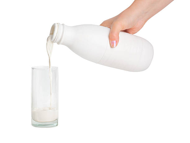 istock Hand with milk bottle and glass 147912957