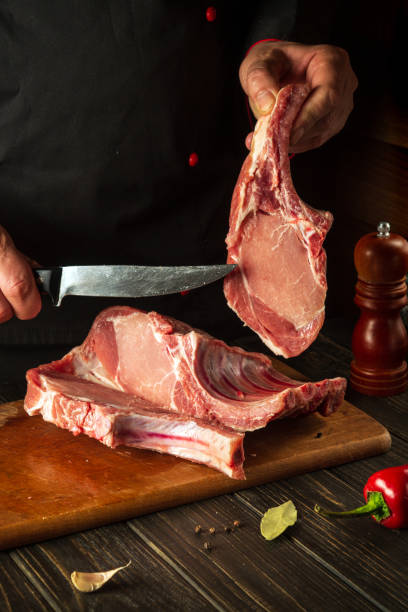 istock A professional chef cuts raw ribs on a cutting board before baking. Asian cuisine. Cooking delicious food in the kitchen 1479130169