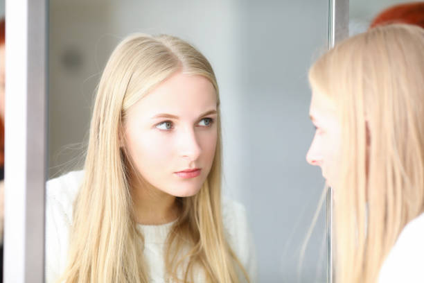 istock Blonde woman looking at mirror, beauty studio 1479131015