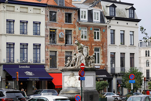 Brussels, Belgium - September 17, 2022: City landscape with historic brick buildings, near which there is a monument