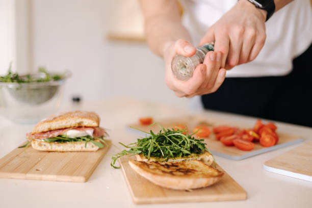 istock Man using pepper grinder for preparing tasty sandwich at home. Middle selection 1479132547